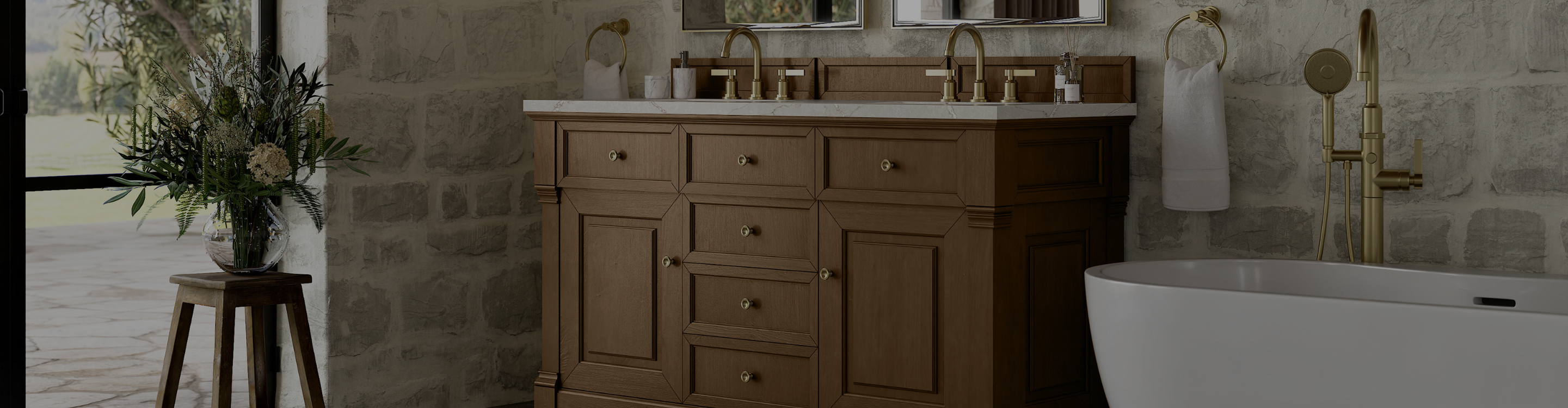 Modern bathroom vanity with gray cabinetry, gold hardware, dual sinks, patterned tiles, dual mirrors, and elegant illuminated lighting for a sophisticated look.