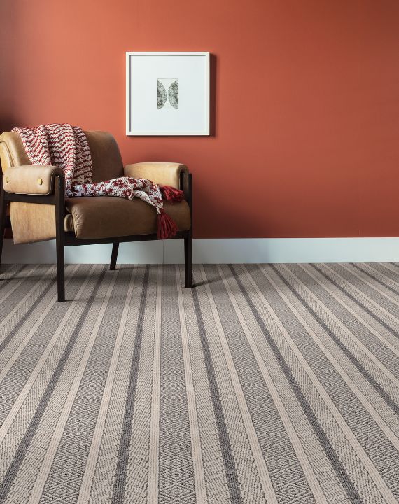Striped area rug with orange wall